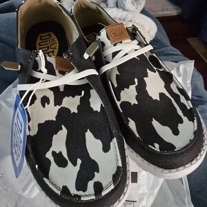 Hey Dude Black and White Cow-Print Slip-On Sneakers